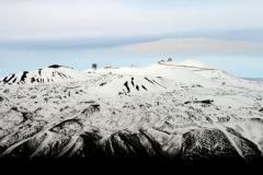 Mauna Kea summit showing observatories.  Shot from south side of mountain.  Road to summit visible.