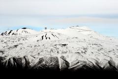 Mauna Kea summit showing observatories.  Shot from south side of mountain. Road to summit visible.